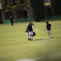 Prep tennis players on field