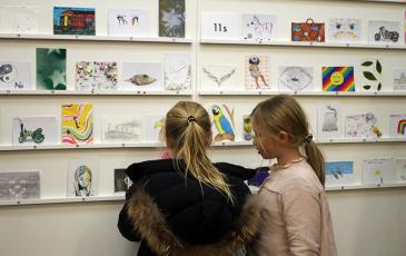 girls looking at postcards